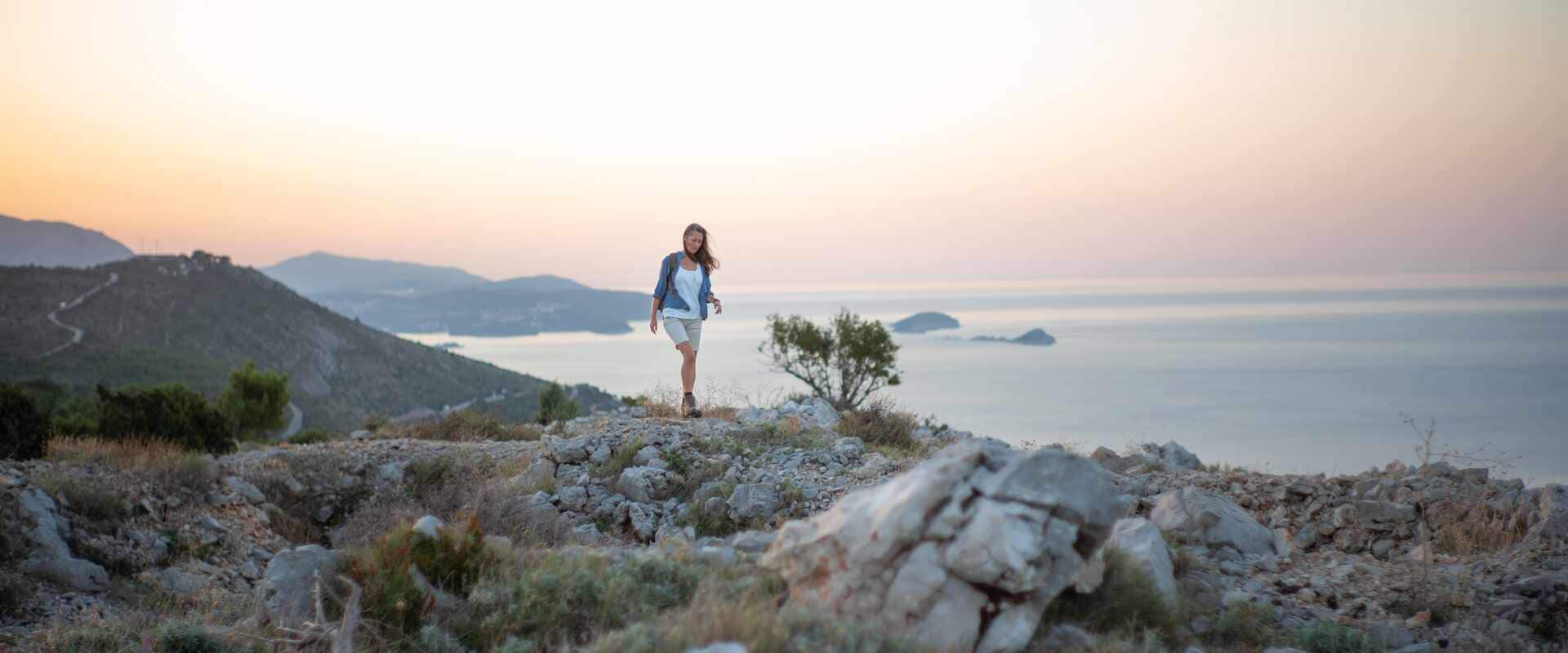 Female walking along deserted rocks area, Croatia